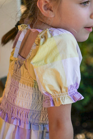 Pastel rainbow-colored dress with floral lace trim